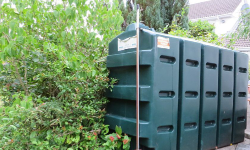 oil tank behind bush